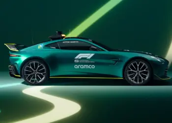 A green Aston Martin F1 car is parked against a dark green background with light green and yellow streaks. The car features branding from Aramco and the FIA Formula 1 World Championship. | MAKE1M
