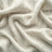 Close-up of soft, white, fluffy fabric with gentle folds and creases, reminiscent of the luxurious textures found in the best cashmere brands. The material appears lightweight and delicate, evoking a sense of warmth and comfort. | MAKE1M