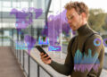 A man in glasses and a turtleneck looks at his smartphone outdoors. Overlay graphics show digital data, charts, and a world map, suggesting analysis or global connectivity. | MAKE1M