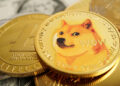 A close-up of several cryptocurrency coins, with a prominent Dogecoin featuring the Shiba Inu dog meme, surrounded by other coins and part of a U.S. dollar bill visible underneath. | MAKE1M